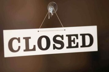 White closed sign on a door