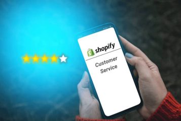 Person holding a mobile phone displaying Shopify Customer Service with next to it 4 out of 5 stars filled in
